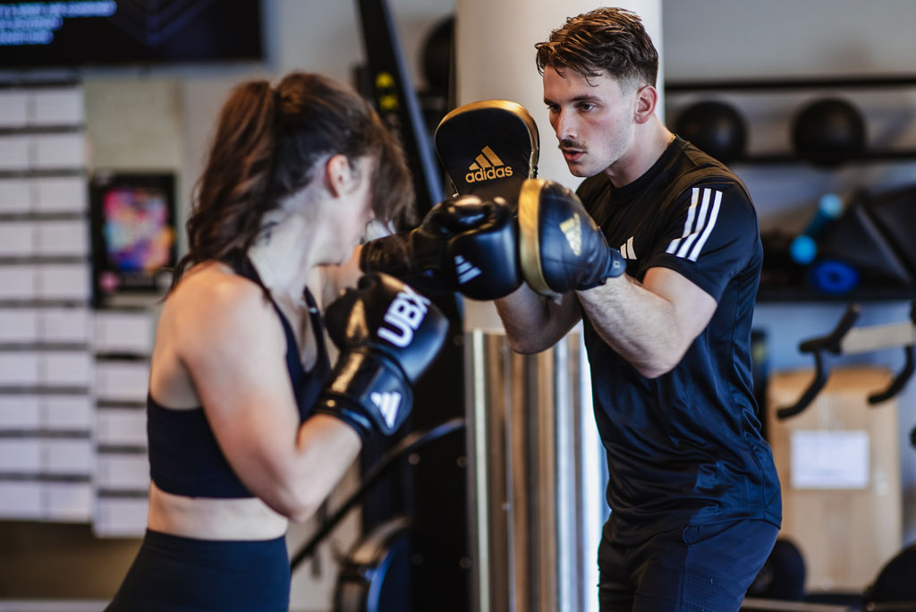 Two people boxing at gym