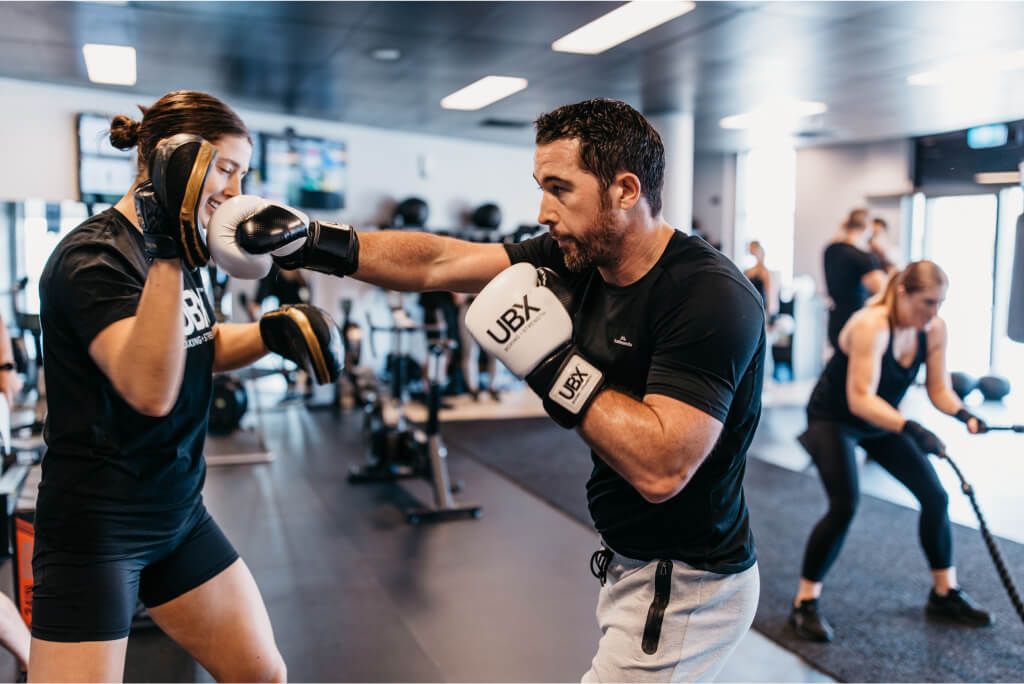 Two people boxing at gym