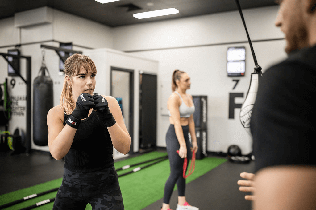 Girl sparring with trainer